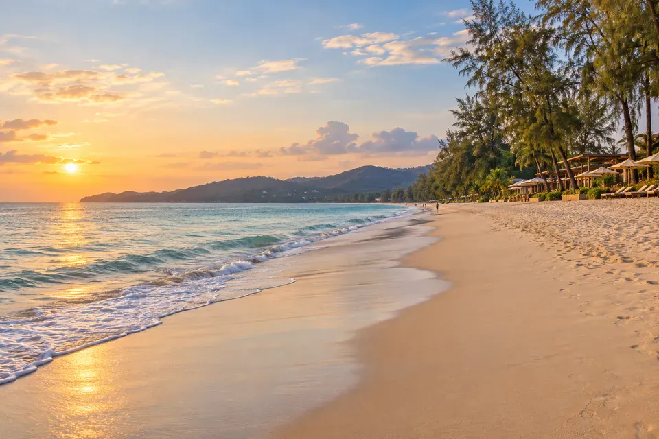 Bang Tao Beach long shoreline, casuarina trees, and calm Andaman water
