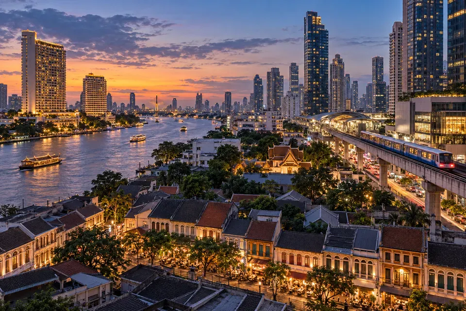 Bangkok riverside, Sukhumvit towers, and a heritage neighborhood at evening