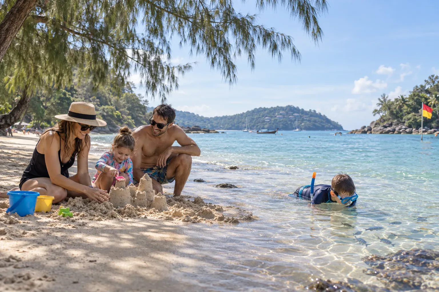 Family enjoying calm shallow water and casuarina shade on a Phuket beach