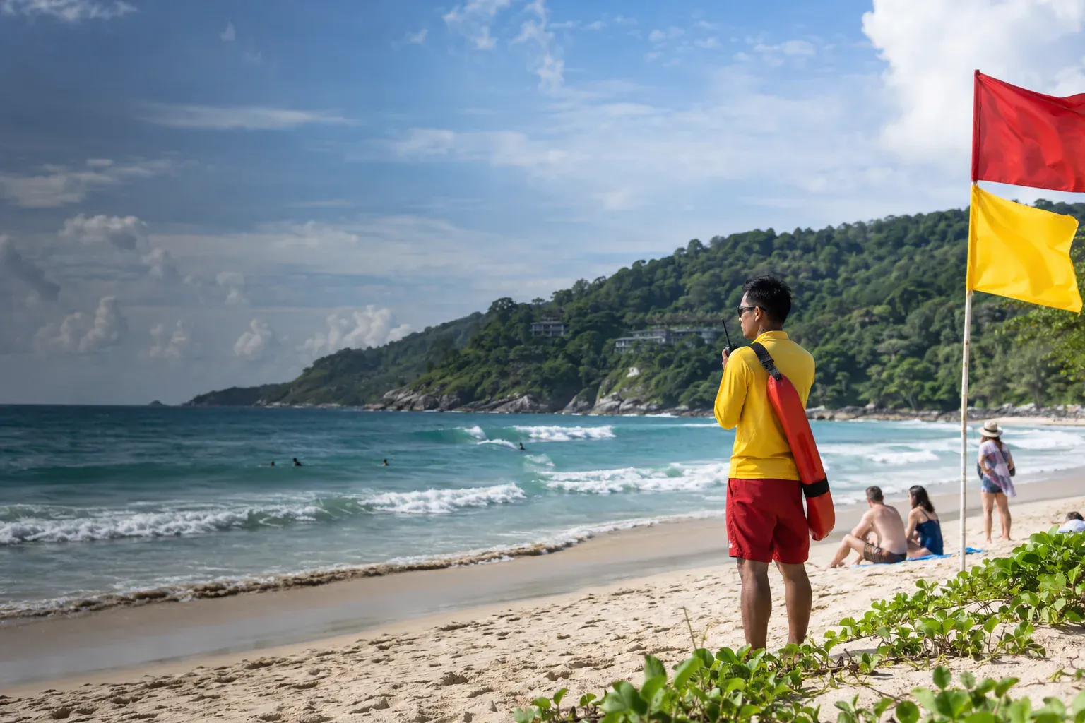 Phuket lifeguard watching a beach marked with red and yellow safety flags